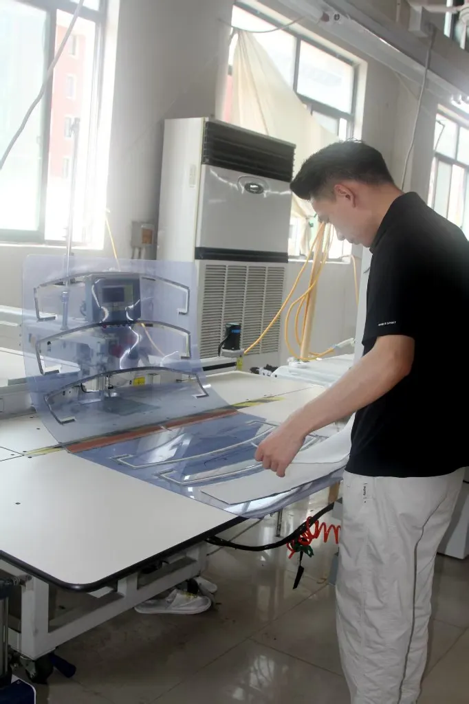 Technician operating precision garment machinery
